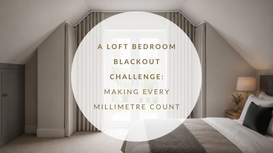 Loft conversion bedroom with French doors, recessed curtain track and curtains extending around return walls for improved blackout performance.