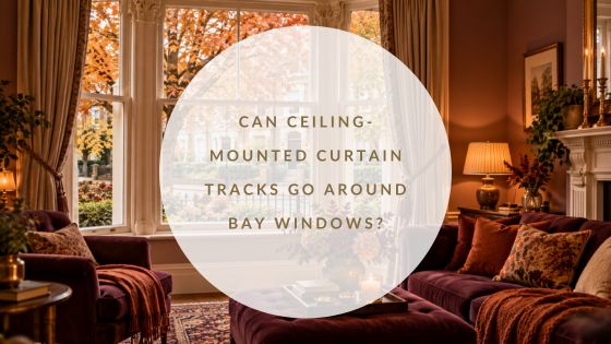 Stylish Victorian living room in warm autumnal colours, looking out through a large bay window onto a leafy British residential street.