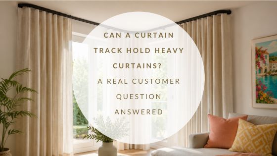 Sunlit living room with heavy cream curtains fitted to a 90 degree curved curtain track around a corner window.